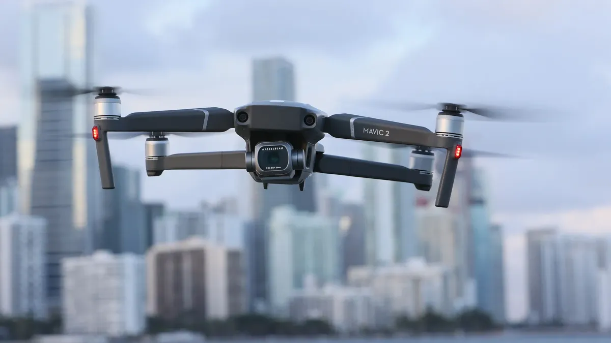 DJI drone hovering over urban Beijing skyline with restricted airspace signage